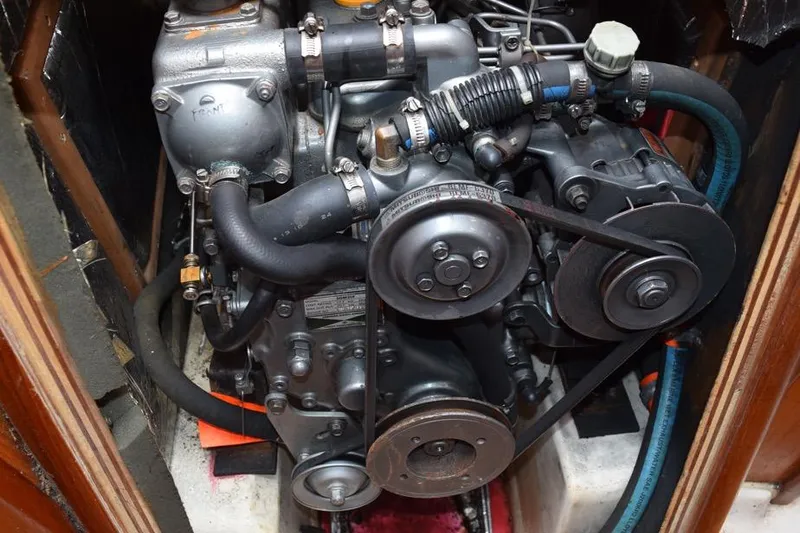 Slide: The Image of Engine of a 2001 Hunter 340 sailboat, showcasing belts and hoses. - 47