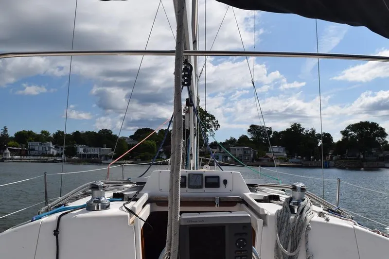 Slide: The Image of Sailing view from a 2001 Hunter 340 yacht, with clear skies and waterfront homes. - 8