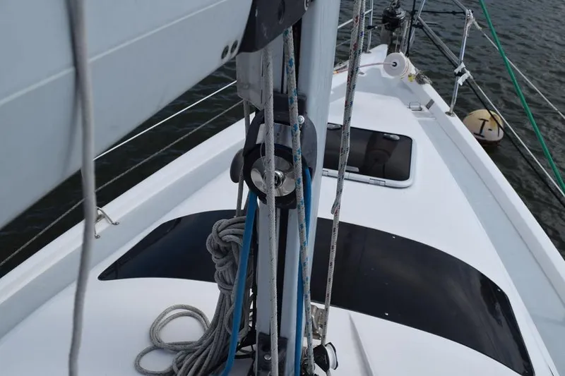 Slide: The Image of 2001 Hunter 340 sailboat deck with rigging and ropes on water. - 9