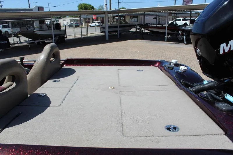 Slide: The Image of 2007 Bass Cat Cougar boat deck with motor, parked in a lot. - 10