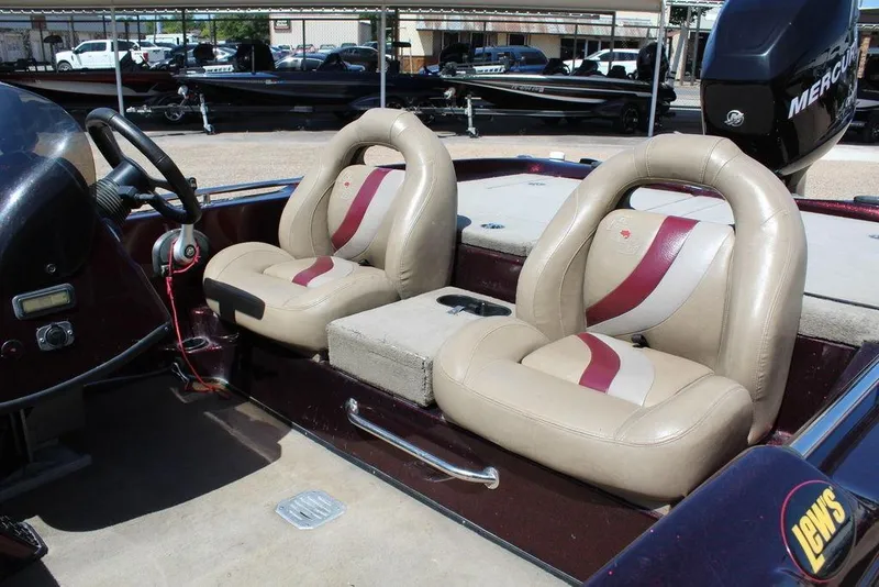 Slide: The Image of 2007 Bass Cat Cougar boat interior with beige and maroon seats, steering wheel, and Mercury engine. - 11