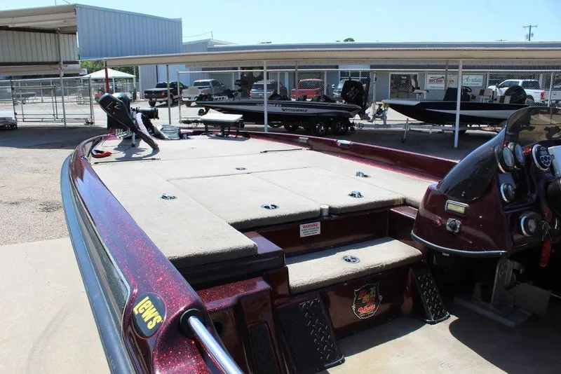 Slide: The Image of 2007 Bass Cat Cougar boat with spacious deck and control panel in a showroom. - 13