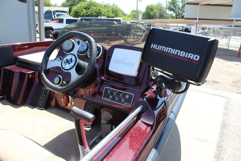 Slide: The Image of 2007 Bass Cat Cougar boat dashboard with steering wheel and Humminbird fish finder. - 15