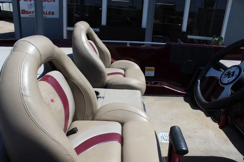 Slide: The Image of 2007 Bass Cat Cougar boat interior with beige and maroon seats, steering wheel visible. - 18