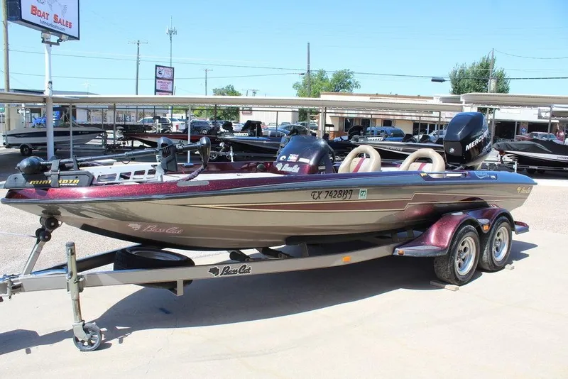 Slide: The Image of 2007 Bass Cat Cougar boat on trailer at dealership, featuring sleek design and Mercury engine. - 3