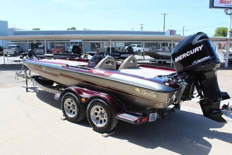 Slide: The Image of 2007 Bass Cat Cougar boat with Mercury OptiMax engine, parked on a trailer. - 4