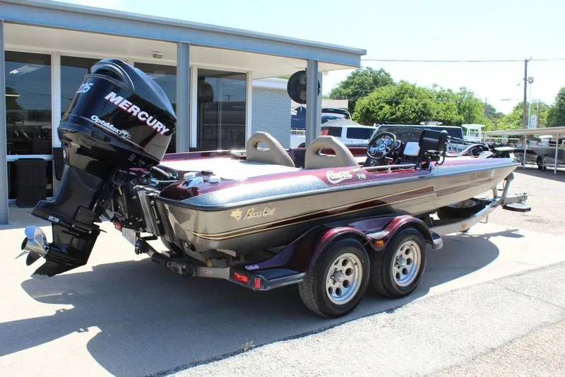 Slide: The Image of 2007 Bass Cat Cougar boat with Mercury engine, parked on a trailer outside a building. - 8