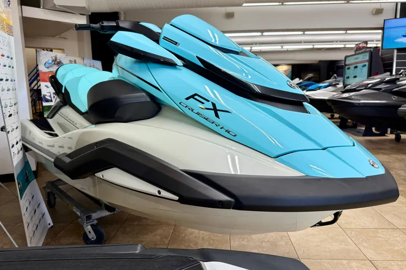 Slide: The Image of 2025 Yamaha WaveRunner FX Cruiser HO in showroom, featuring sleek blue design. - 2