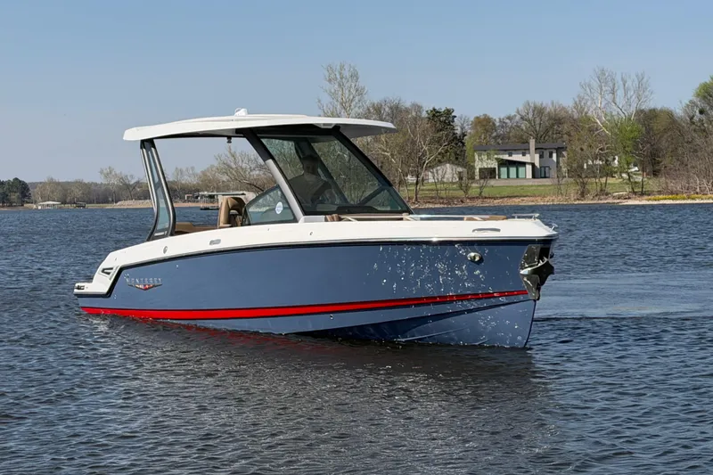 The Image of 2026 Monterey Elite 27 SD boat cruising on a calm lake with scenic background. - 0