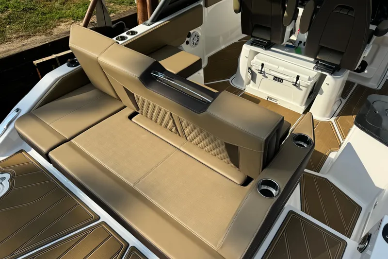 Slide: The Image of 2026 Monterey Elite 27 SD boat interior with tan seating and cup holders. - 10