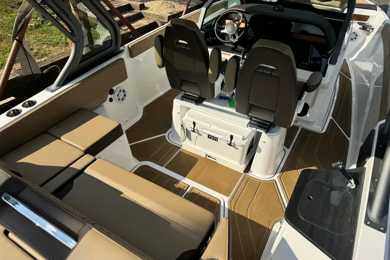 Slide: The Image of 2026 Monterey Elite 27 SD boat interior with tan seating and modern dashboard. - 11