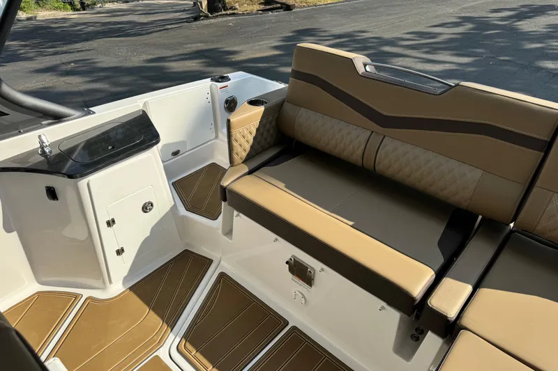 Slide: The Image of 2026 Monterey Elite 27 SD boat interior with tan seating and sleek design. - 13