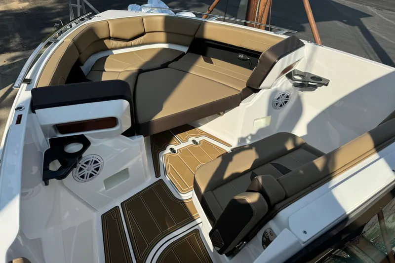 Slide: The Image of 2026 Monterey Elite 27 SD boat interior with tan seating and cup holders. - 14