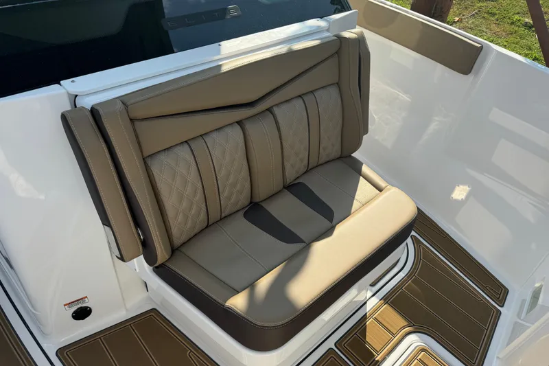Slide: The Image of Luxurious seating on 2026 Monterey Elite 27 SD boat, featuring elegant brown upholstery. - 15