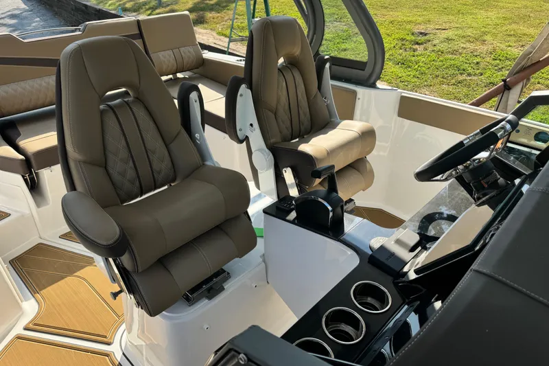 Slide: The Image of Luxurious interior of 2026 Monterey Elite 27 SD boat with plush seating and modern dashboard. - 17
