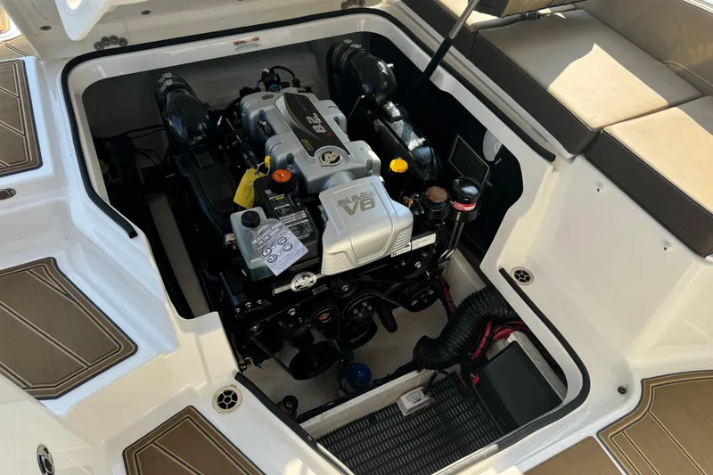 Slide: The Image of Engine compartment of 2026 Monterey Elite 27 SD boat, showcasing powerful V8 engine. - 19