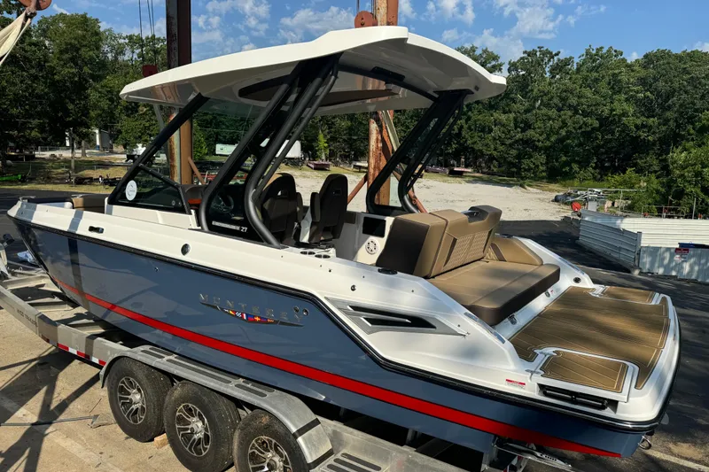 Slide: The Image of 2026 Monterey Elite 27 SD boat on trailer, featuring sleek design and spacious seating. - 4