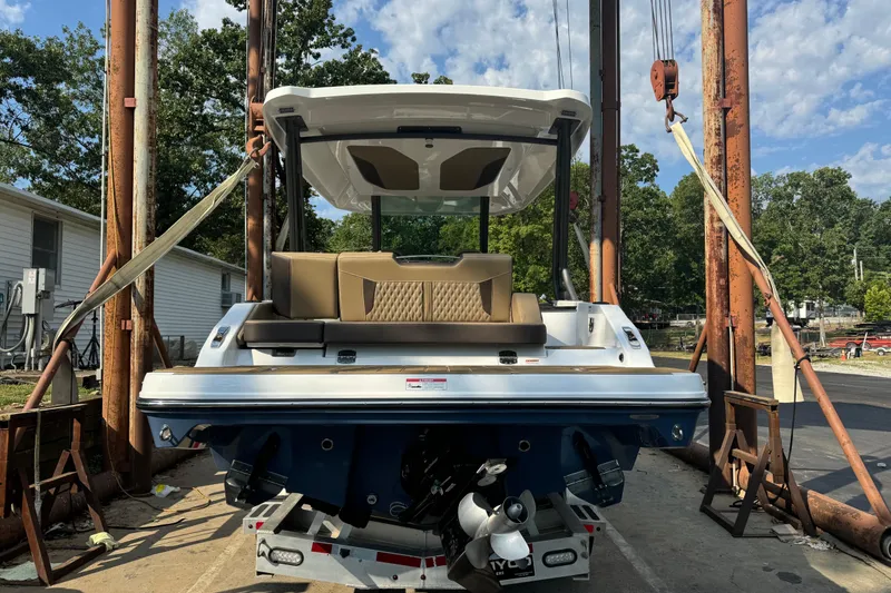 Slide: The Image of 2026 Monterey Elite 27 SD boat on lift, showcasing rear view and seating area. - 5