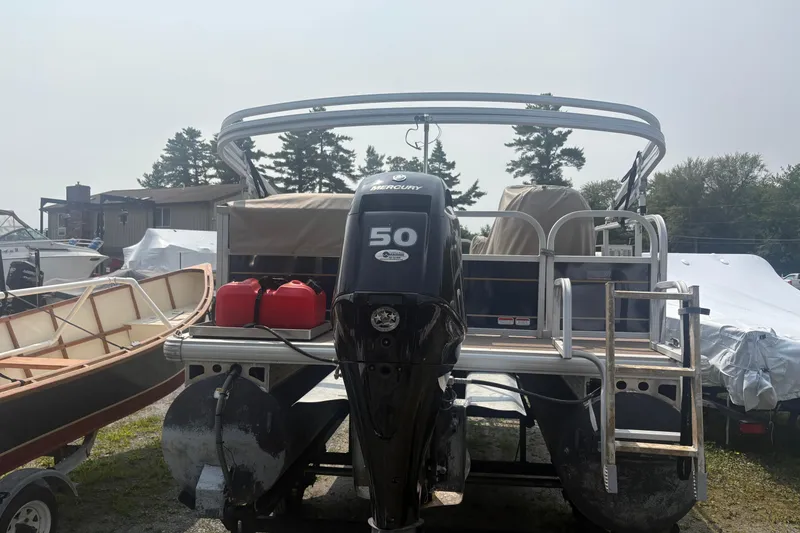 Slide: The Image of 2022 Sun Tracker Bass Buggy 16 XL pontoon boat with Mercury 50 engine, docked outdoors. - 4