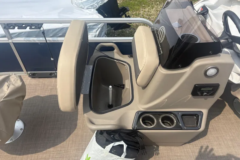Slide: The Image of 2022 Sun Tracker Bass Buggy 16 XL boat console with storage and cup holders. - 8