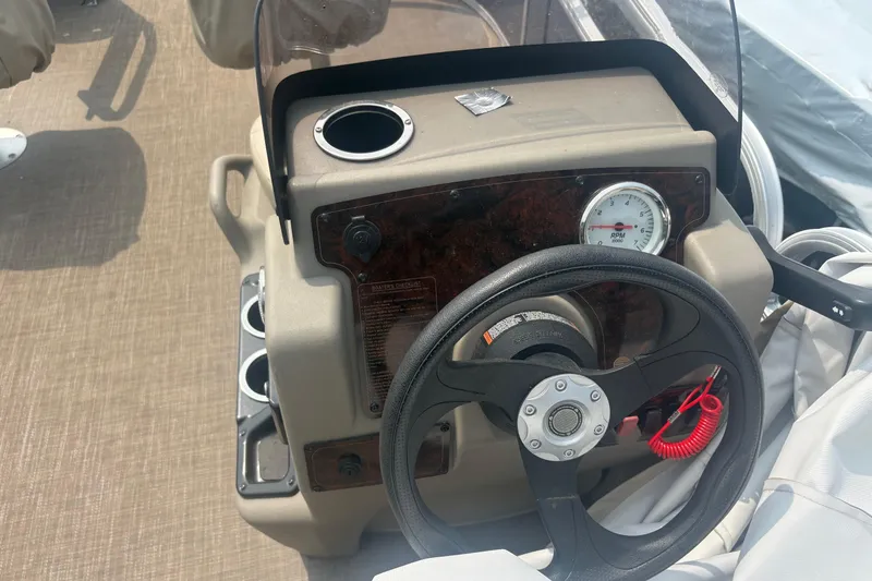 Slide: The Image of Steering console of 2022 Sun Tracker Bass Buggy 16 XL with RPM gauge and cup holder. - 9