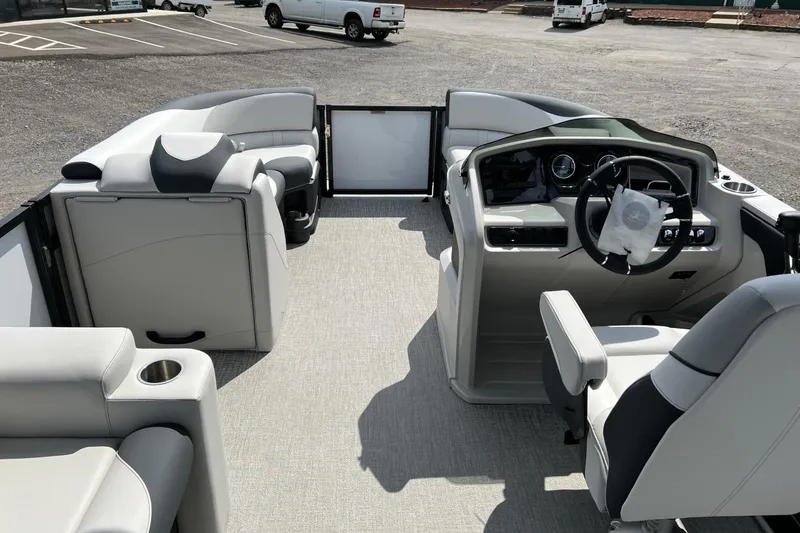 Slide: The Image of 2026 Tahoe TRITOON 2185 boat interior with modern seating and steering console. - 12