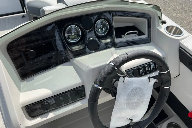 Slide: The Image of 2026 Tahoe TRITOON 2185 dashboard with steering wheel and control panel. - 13