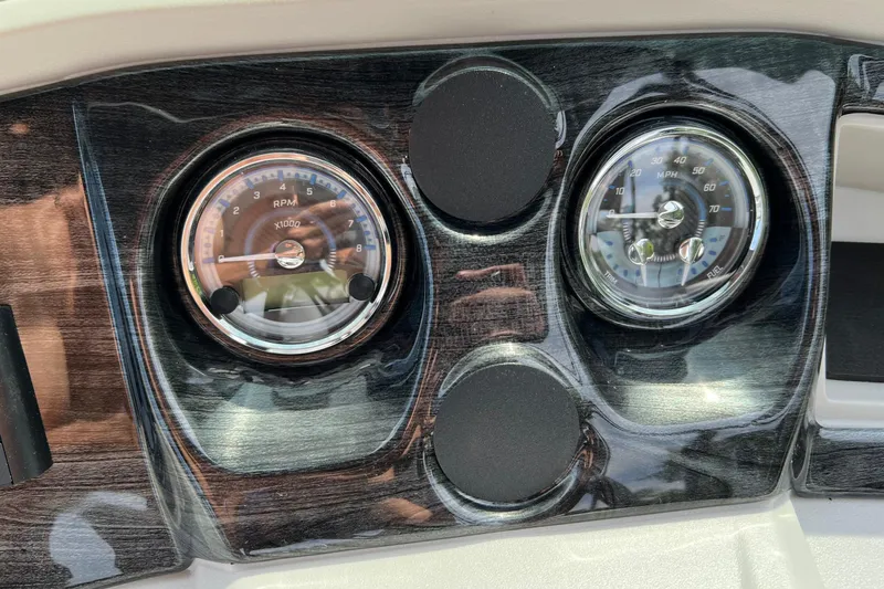 Slide: The Image of Dashboard of 2026 Tahoe TRITOON 2185 with RPM and speed gauges. - 14