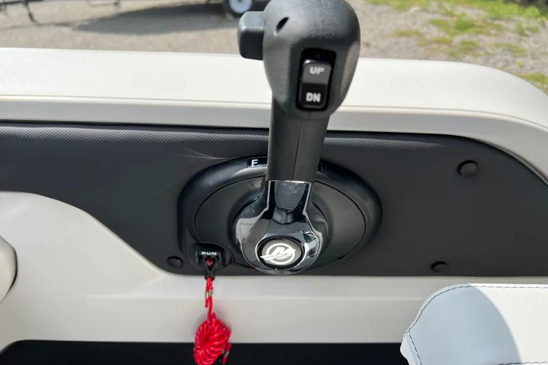 Slide: The Image of Close-up of 2026 Tahoe TRITOON 2185 boat throttle control with red safety lanyard. - 19
