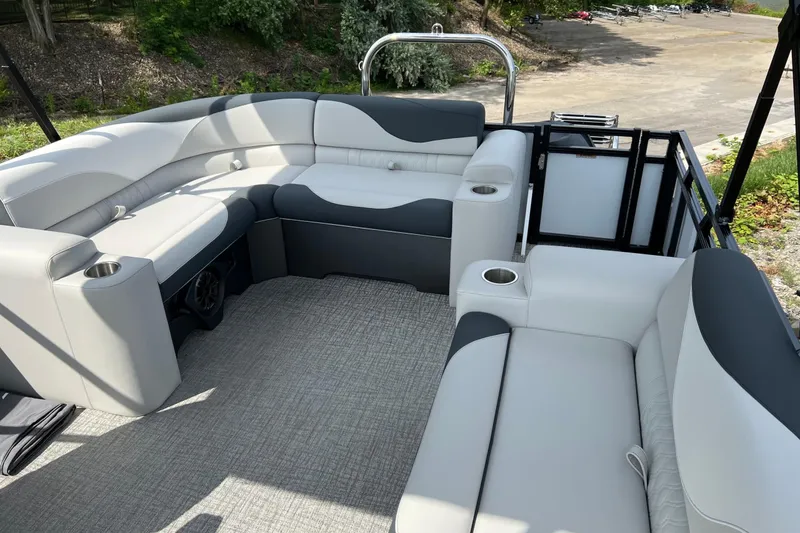 Slide: The Image of 2026 Tahoe TRITOON 2185 interior with gray seating and cup holders, parked outdoors. - 23