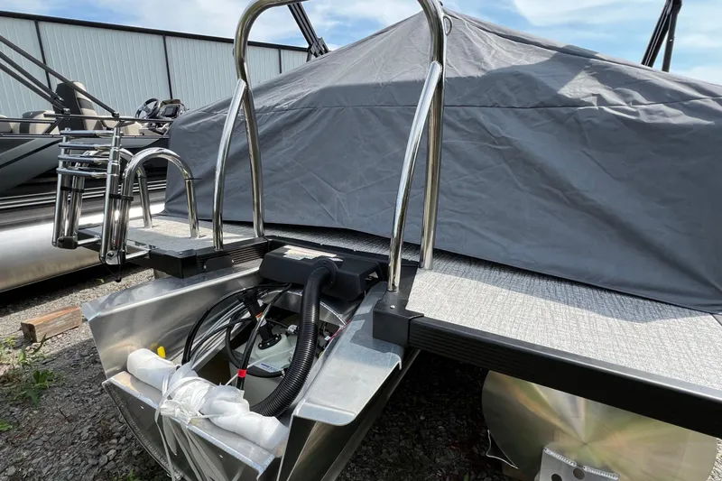 Slide: The Image of 2026 Tahoe TRITOON 2185 boat with cover, featuring stainless steel ladder and pontoons. - 28