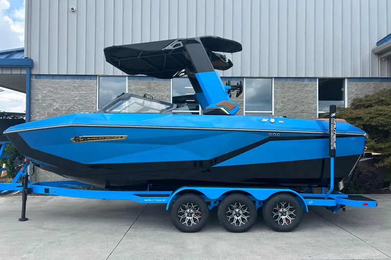 Slide: The Image of 2026 Nautique Super Air Nautique G23 boat in vibrant blue on a trailer. - 0