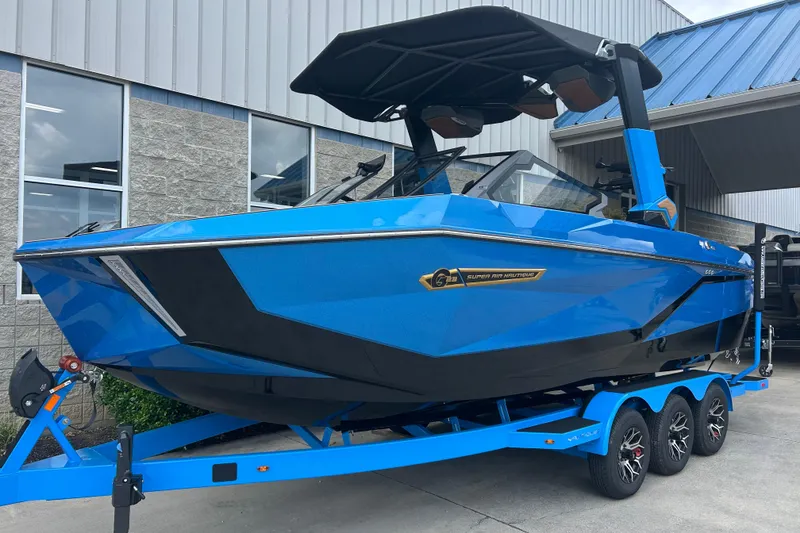 Slide: The Image of 2026 Nautique Super Air Nautique G23 boat in vibrant blue on a trailer. - 1