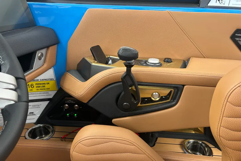 Slide: The Image of Interior of 2026 Nautique Super Air Nautique G23, featuring tan leather and control panel. - 10