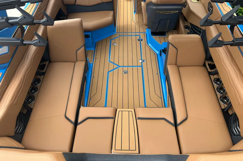 Slide: The Image of Luxurious interior of 2026 Nautique Super Air Nautique G23 with tan seating and blue accents. - 12