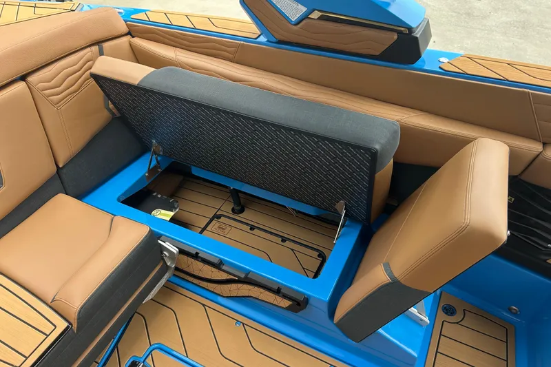 Slide: The Image of 2026 Nautique Super Air Nautique G23 interior with tan and blue seating. - 14