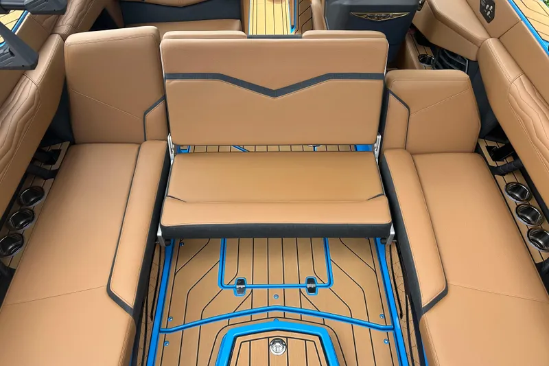 Slide: The Image of Luxurious interior of 2026 Nautique Super Air Nautique G23 with tan seating and blue accents. - 16