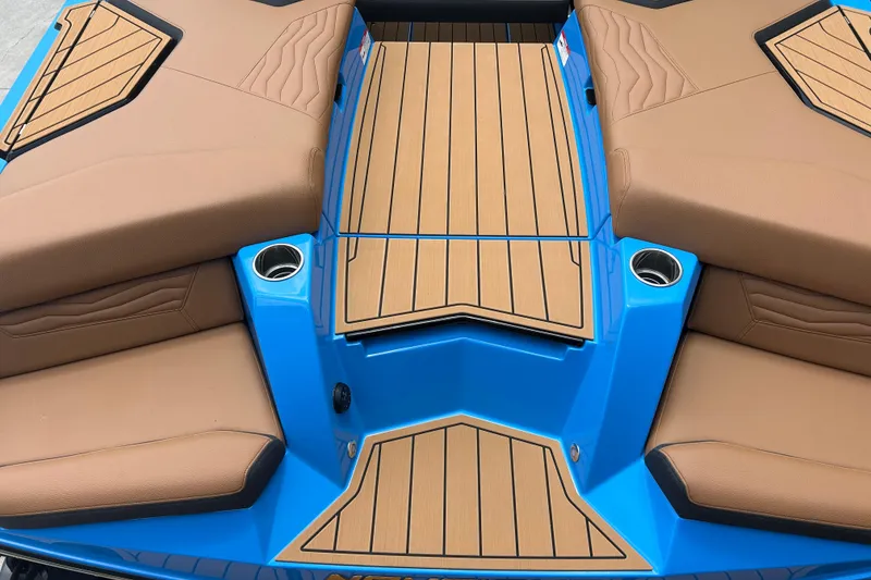 Slide: The Image of 2026 Nautique Super Air Nautique G23 boat interior with tan seats and blue accents. - 17