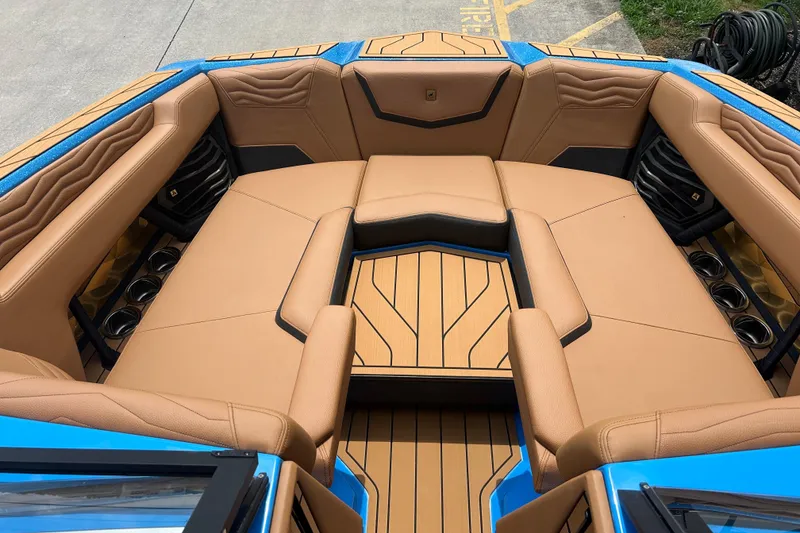 Slide: The Image of 2026 Nautique Super Air Nautique G23 interior with tan leather seating and blue accents. - 18