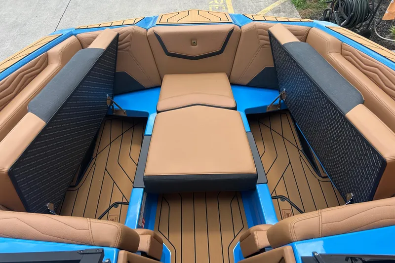 Slide: The Image of 2026 Nautique Super Air Nautique G23 boat interior with tan and blue seating. - 19