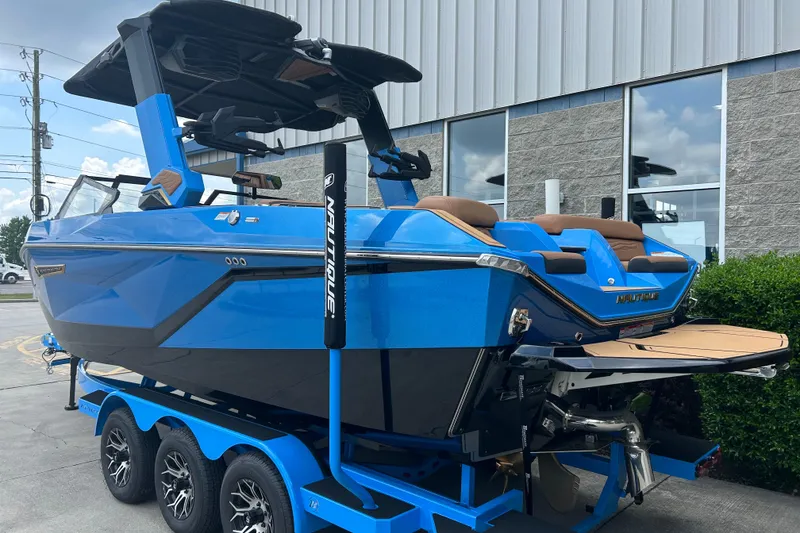 Slide: The Image of 2026 Nautique Super Air Nautique G23 boat in vibrant blue on a trailer. - 2