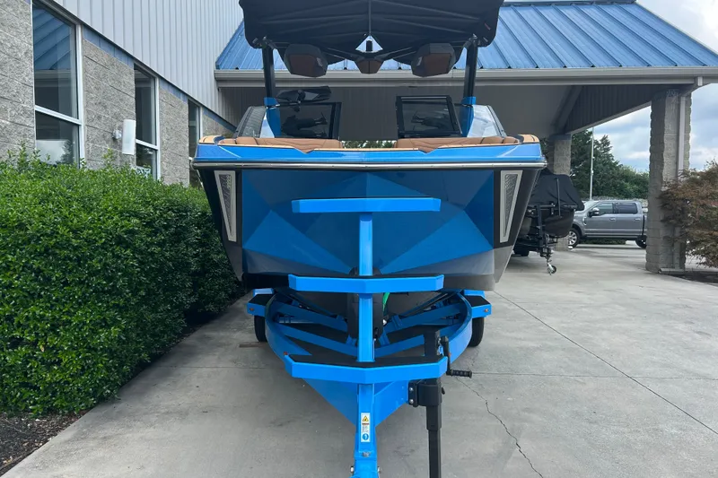 Slide: The Image of 2026 Nautique Super Air Nautique G23 boat in vibrant blue, parked outdoors. - 4