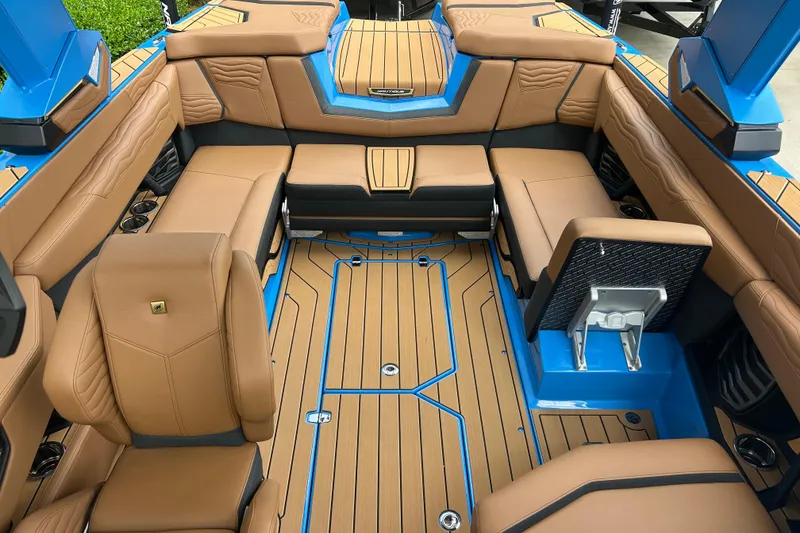 Slide: The Image of 2026 Nautique Super Air Nautique G23 interior with tan seating and blue accents. - 6
