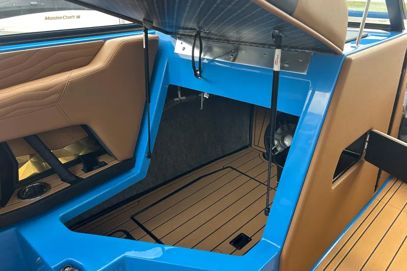 Slide: The Image of 2026 Nautique Super Air Nautique G23 interior storage compartment with blue and tan accents. - 8