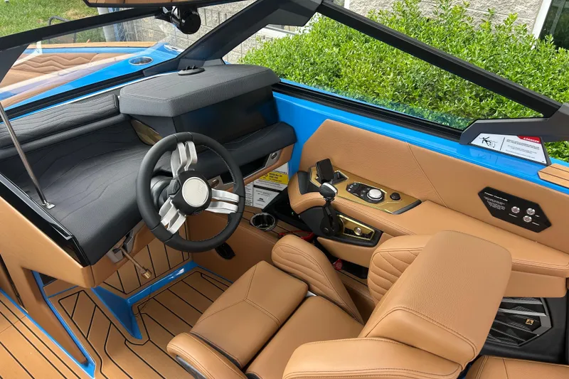 Slide: The Image of 2026 Nautique Super Air Nautique G23 interior with tan leather seats and modern controls. - 9