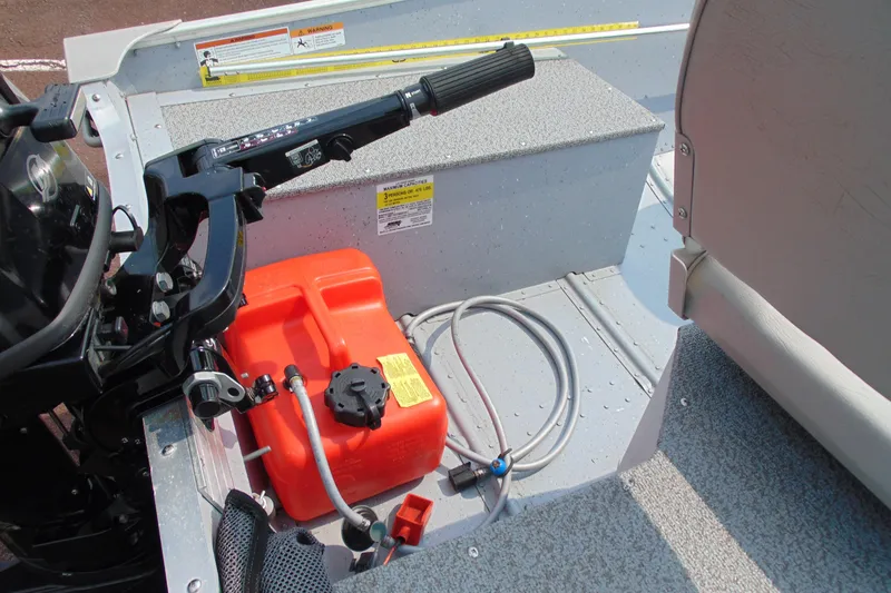 Slide: The Image of 2022 Crestliner 1261 Outreach boat interior with motor controls and fuel tank. - 10