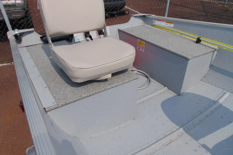 Slide: The Image of 2022 Crestliner 1261 Outreach boat interior with seating and storage compartments. - 7