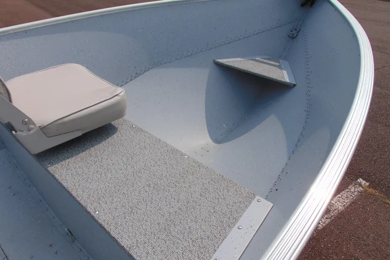 Slide: The Image of 2022 Crestliner 1261 Outreach boat interior with seating and non-slip flooring. - 8