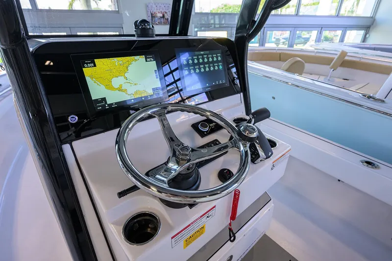 Slide: The Image of 2026 Sportsman Masters 247OE Bay Boat dashboard with navigation screens and steering wheel. - 15