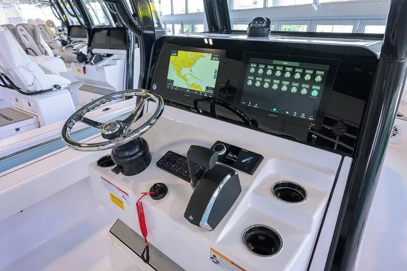 Slide: The Image of 2026 Sportsman Masters 247OE Bay Boat dashboard with steering wheel and digital displays. - 16